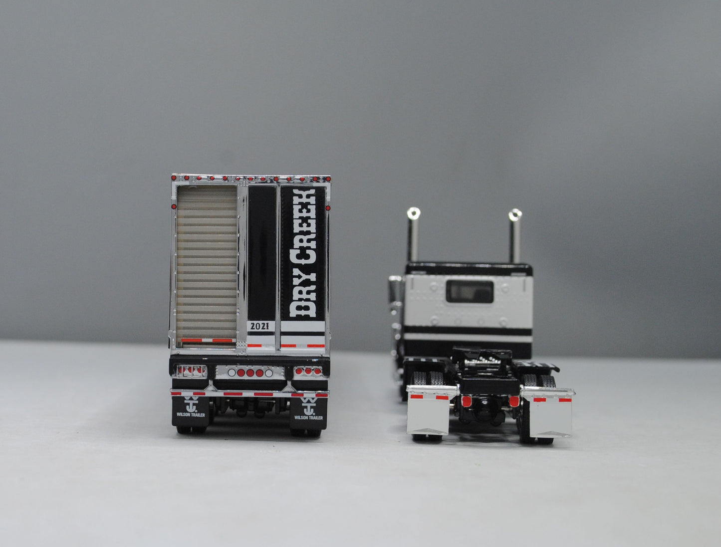 #60-1049 Dry Creek Trucking Black White Peterbilt Wilson Black Tri-Axle Livestock Trailer